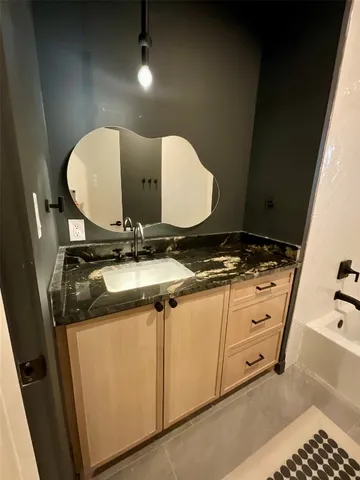 a large kitchen with kitchen island a counter top and stainless steel appliances