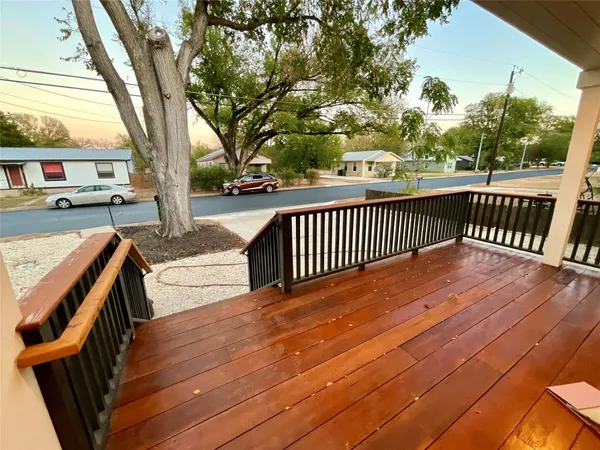 a view of a wooden deck and a yard