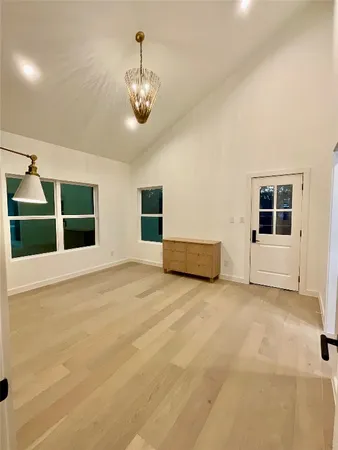 an empty room with closet and windows