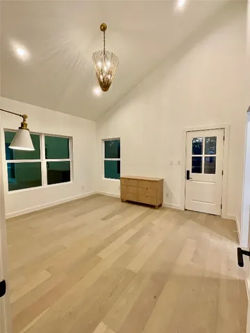 an empty room with closet and windows
