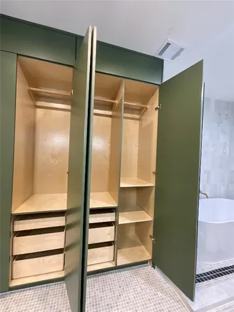 a bathroom with a sink a toilet a mirror and shower