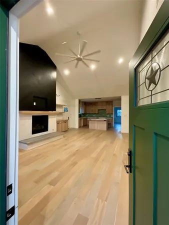 an empty room with furniture and a flat screen tv