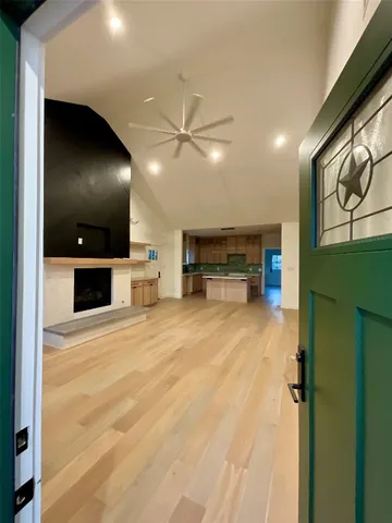 an empty room with furniture and a flat screen tv