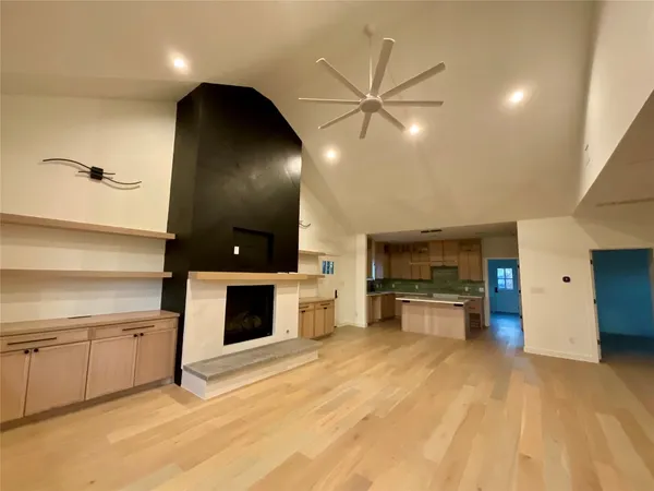 a view of street with small yard and wooden fence