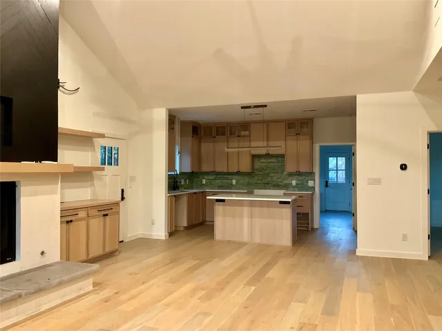 a view of a kitchen with a sink and a stove top oven