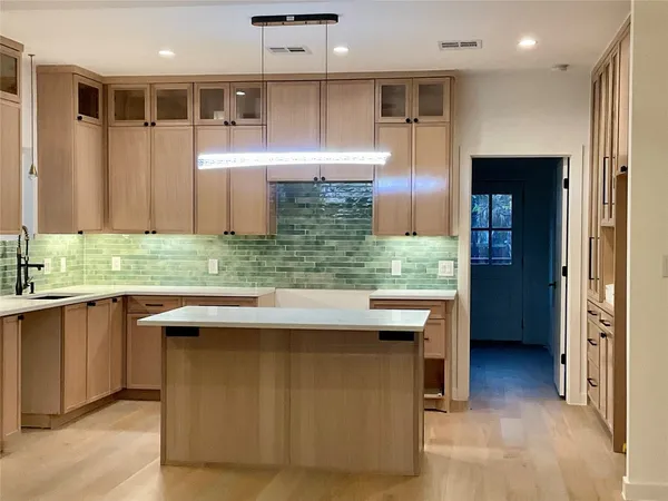 a view of a kitchen with a sink a refrigerator and a stove top oven