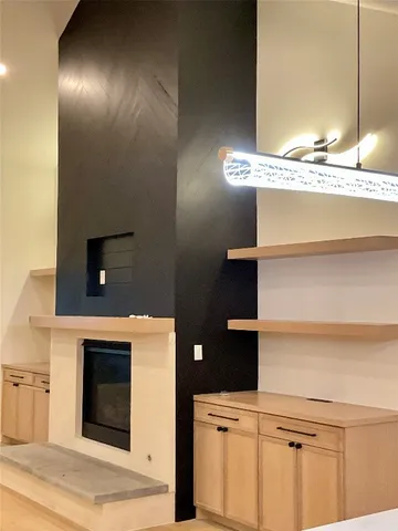 a kitchen with kitchen island a counter top space a sink stainless steel appliances and cabinets