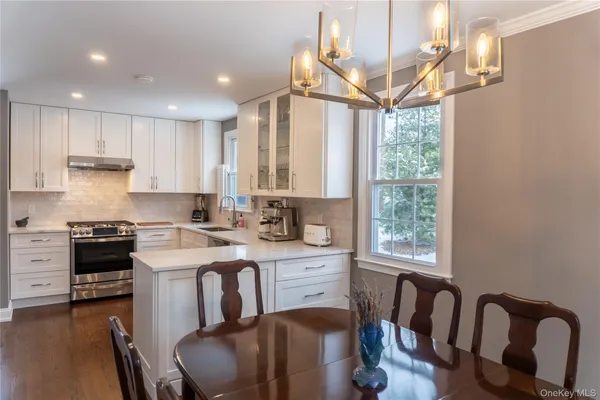 a kitchen with a table chairs stove and cabinets