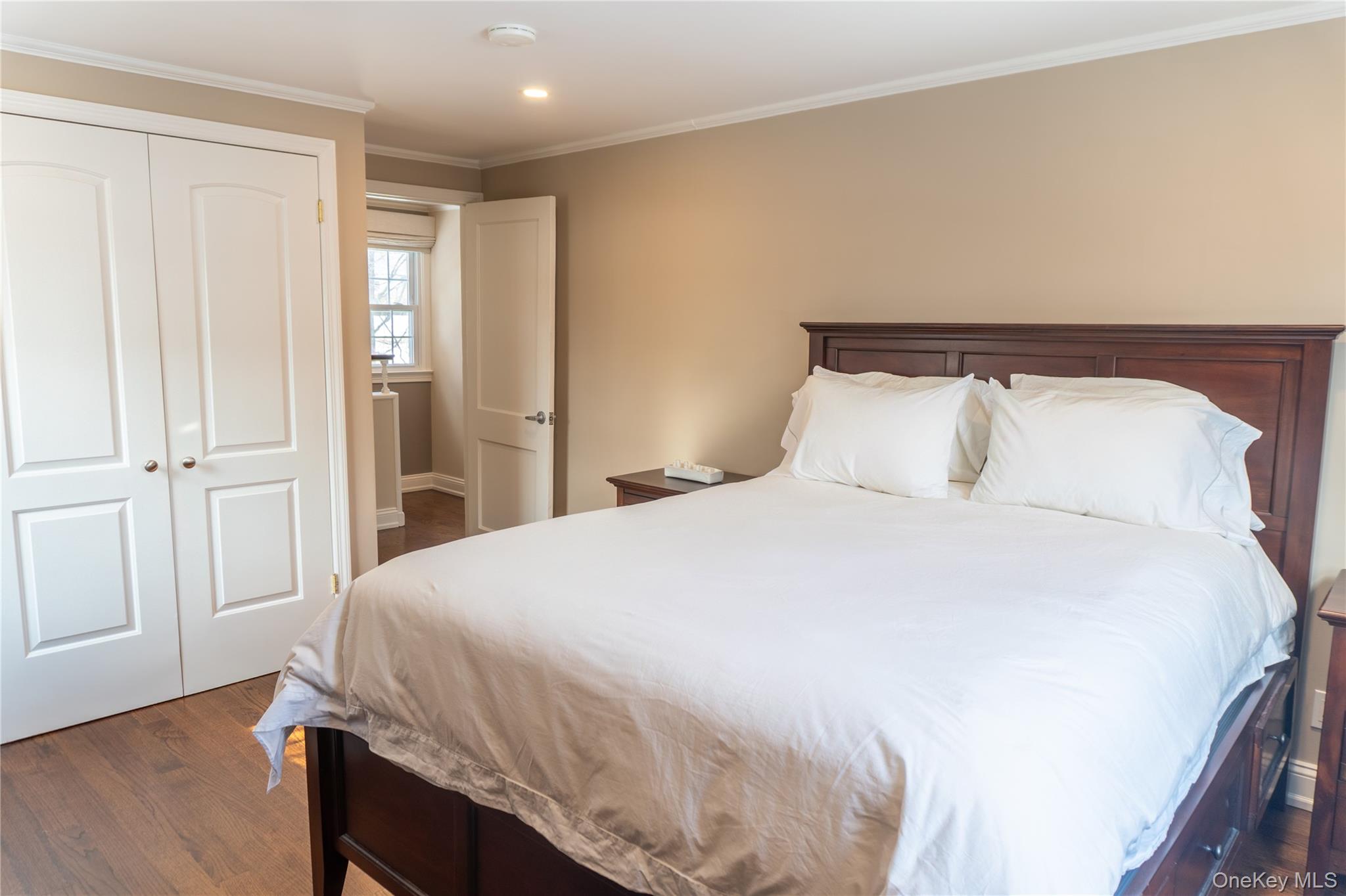 93 Beverly Road White Plains, NY 10605 - Photo 9 of 14 a bedroom with a bed and wooden floor