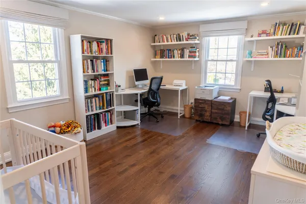 a living room with furniture and a book shelf