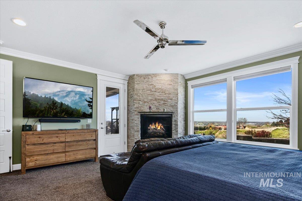 24053 Pheasant Ridge Court Middleton, ID 83644 - Photo 18 of 50 Bedroom featuring dark carpet, a fireplace, ornamental molding, ceiling fan, and recessed lighting