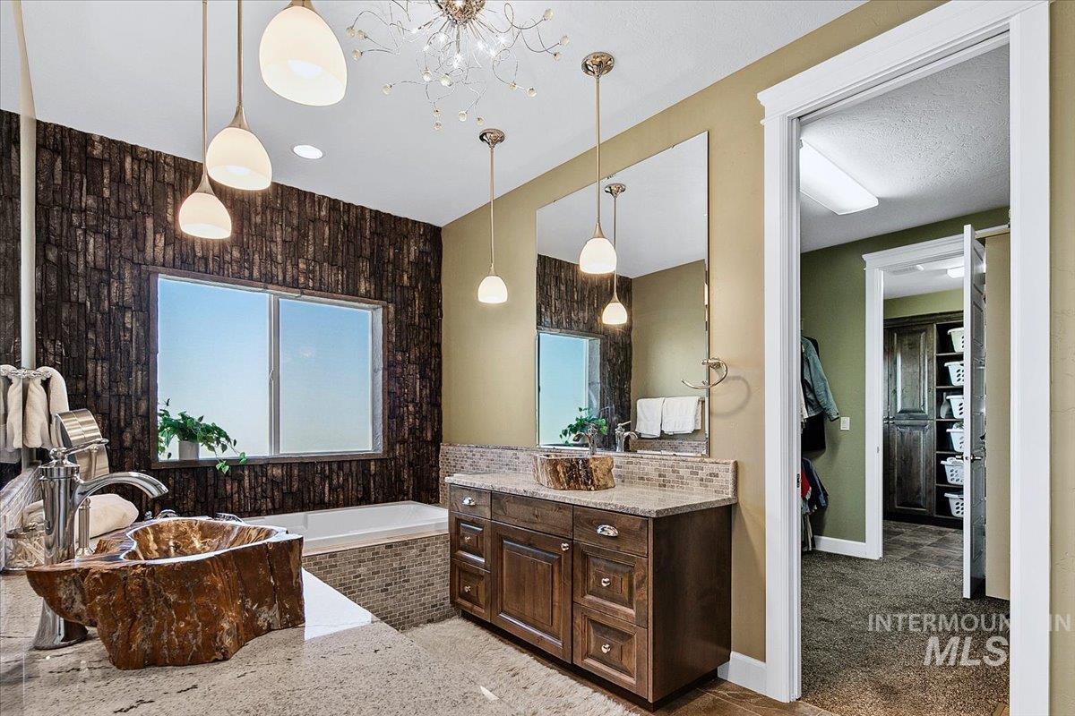 24053 Pheasant Ridge Court Middleton, ID 83644 - Photo 21 of 50 Bathroom featuring a bath, vanity, and light colored carpet
