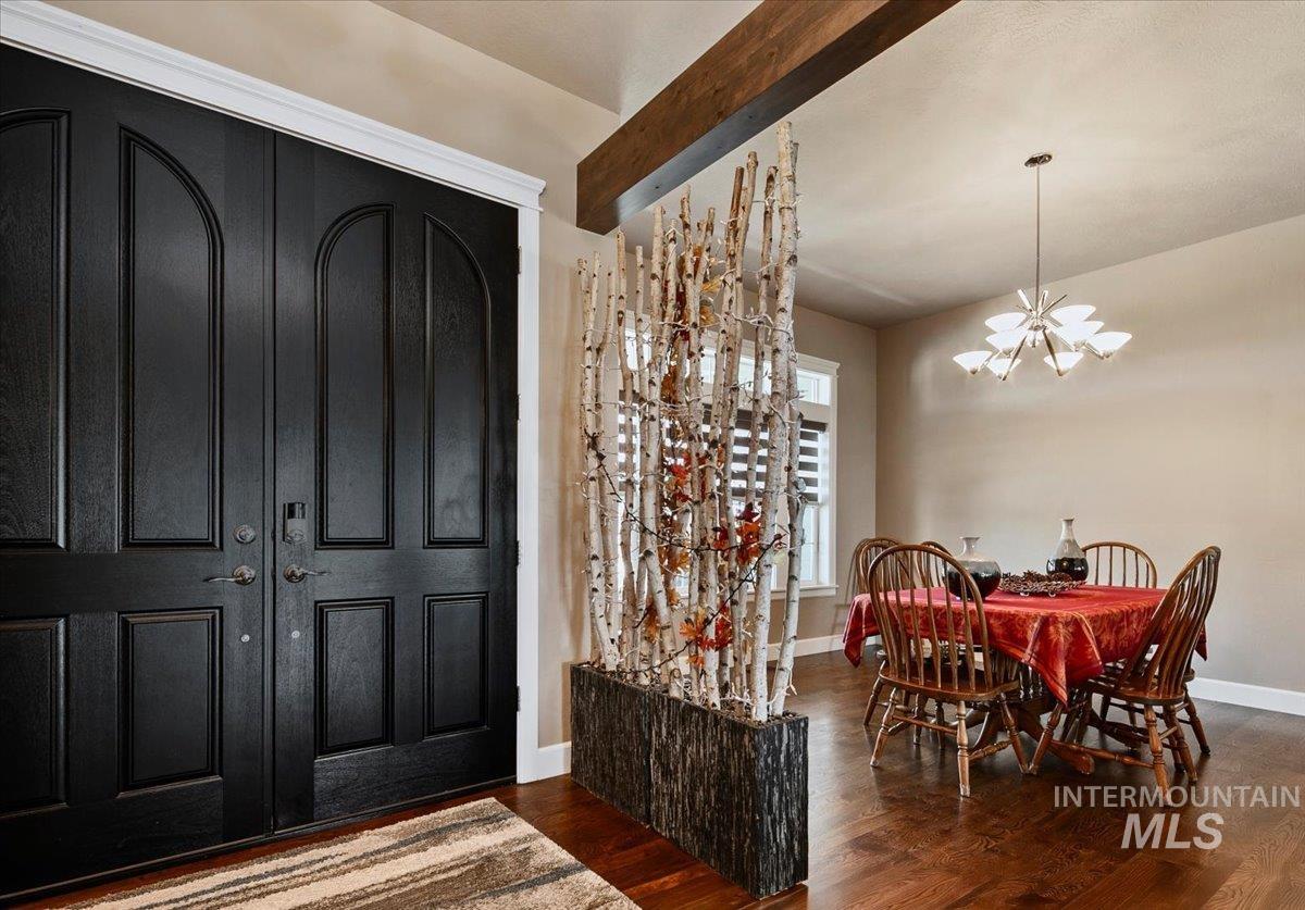 24053 Pheasant Ridge Court Middleton, ID 83644 - Photo 6 of 50 Entryway with hanging lights, beamed ceiling, and dark wood-type flooring