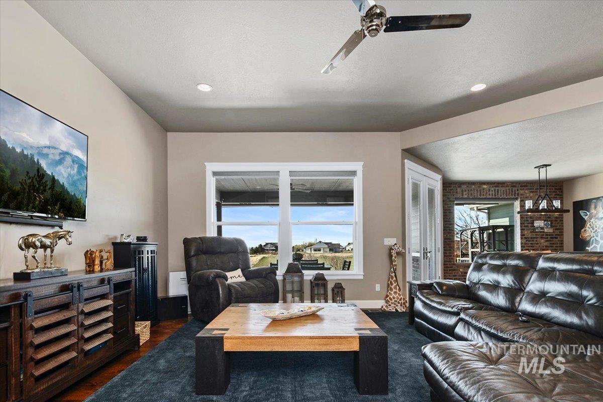 24053 Pheasant Ridge Court Middleton, ID 83644 - Photo 8 of 50 Living room featuring ceiling fan, a textured ceiling, and recessed lighting