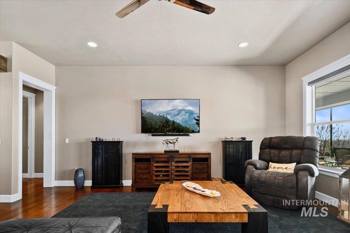 24053 Pheasant Ridge Court Middleton, ID 83644 - Photo 9 of 50 Living room featuring ceiling fan, dark wood-style floors, and recessed lighting