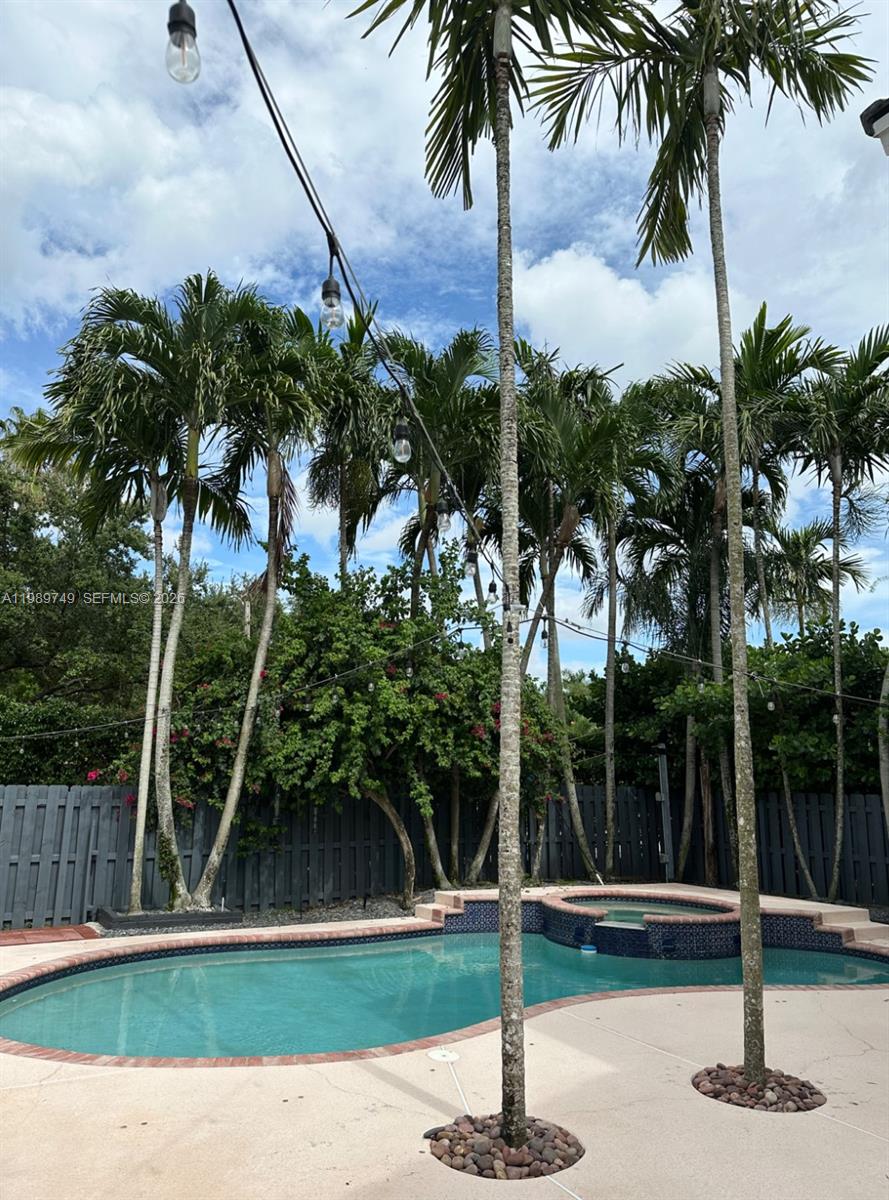 4021 Southwest 153rd Avenue Miramar, FL 33027 - Photo 18 of 42 a house with palm tree in front of it