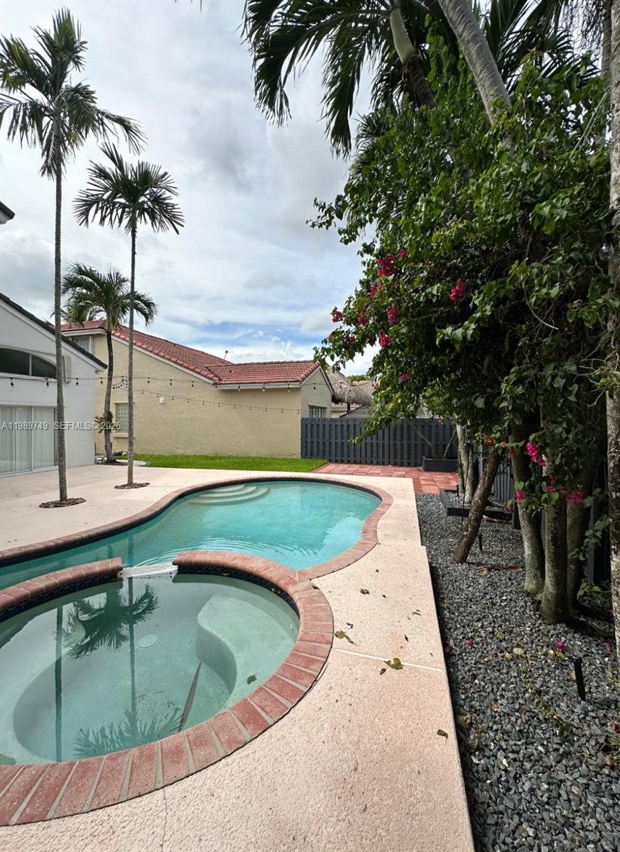 4021 Southwest 153rd Avenue Miramar, FL 33027 - Photo 19 of 42 a view of swimming pool with a table and chairs