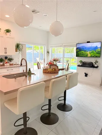 a dining room with furniture and a floor to ceiling window