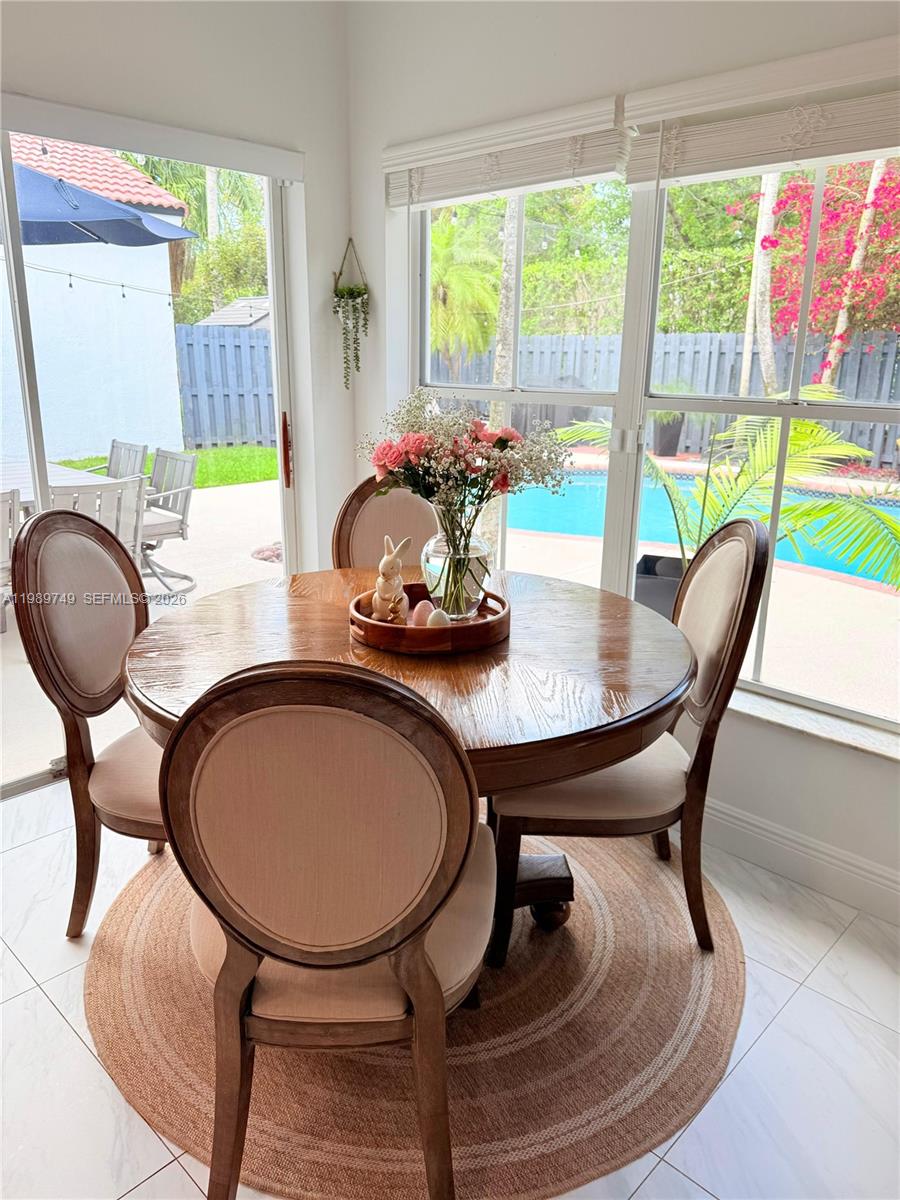 4021 Southwest 153rd Avenue Miramar, FL 33027 - Photo 25 of 42 a dining room with furniture a rug and a mirror