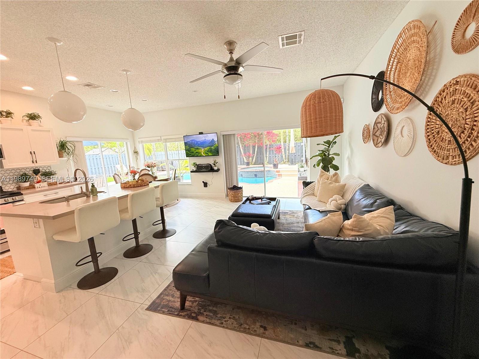 4021 Southwest 153rd Avenue Miramar, FL 33027 - Photo 31 of 42 a living room with furniture and kitchen view
