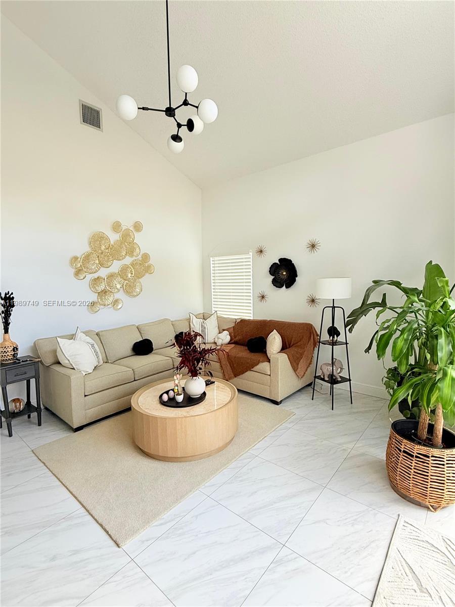 4021 Southwest 153rd Avenue Miramar, FL 33027 - Photo 35 of 42 a living room with furniture and a potted plant