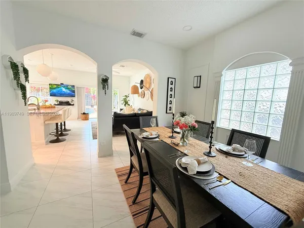 a dining room with furniture and window