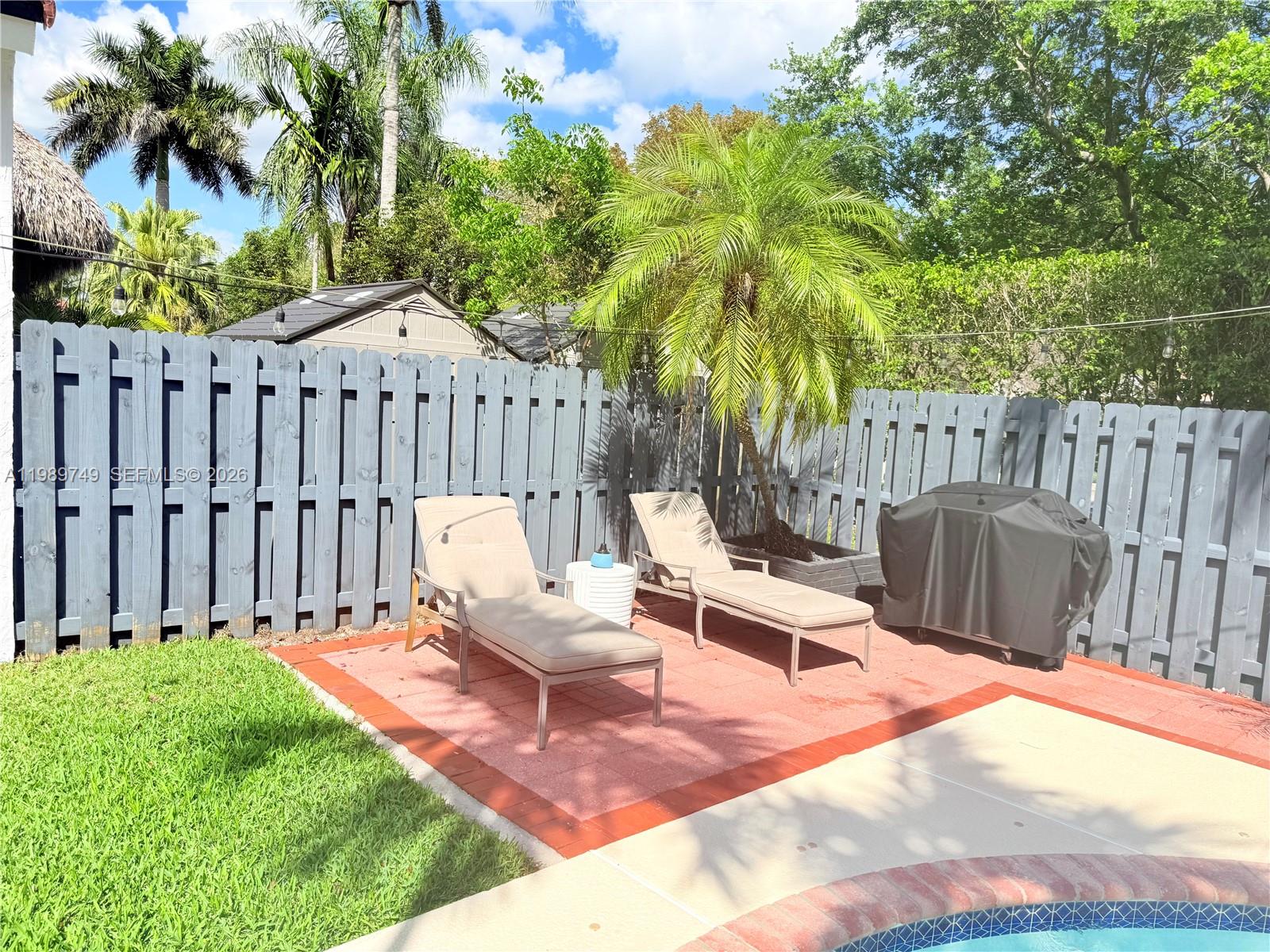 4021 Southwest 153rd Avenue Miramar, FL 33027 - Photo 40 of 42 a view of a wooden deck with a bench