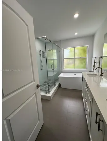 a bathroom with a sink a mirror and a bathtub