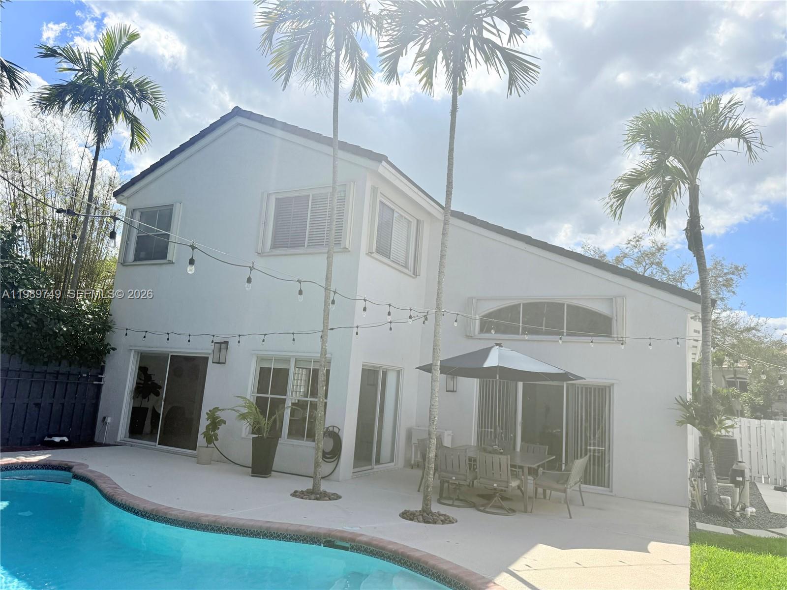 4021 Southwest 153rd Avenue Miramar, FL 33027 - Photo 42 of 42 a view of a white house with a yard and potted plants