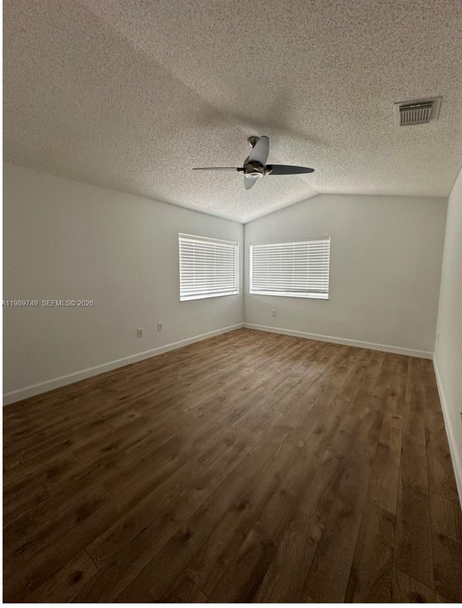 4021 Southwest 153rd Avenue Miramar, FL 33027 - Photo 5 of 42 an empty room with wooden floor and windows