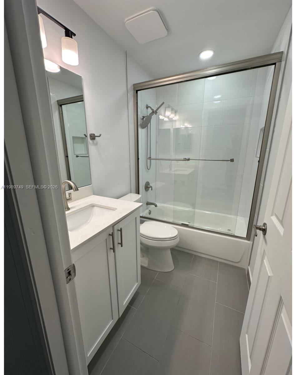 4021 Southwest 153rd Avenue Miramar, FL 33027 - Photo 6 of 42 a bathroom with a granite countertop sink toilet and shower