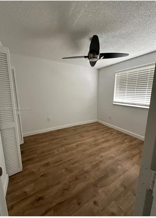 a view of a room with wooden floor and windows