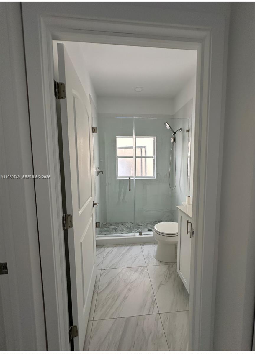 4021 Southwest 153rd Avenue Miramar, FL 33027 - Photo 8 of 42 a bathroom with a granite countertop toilet and a shower