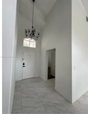 a view of a hallway with a chandelier