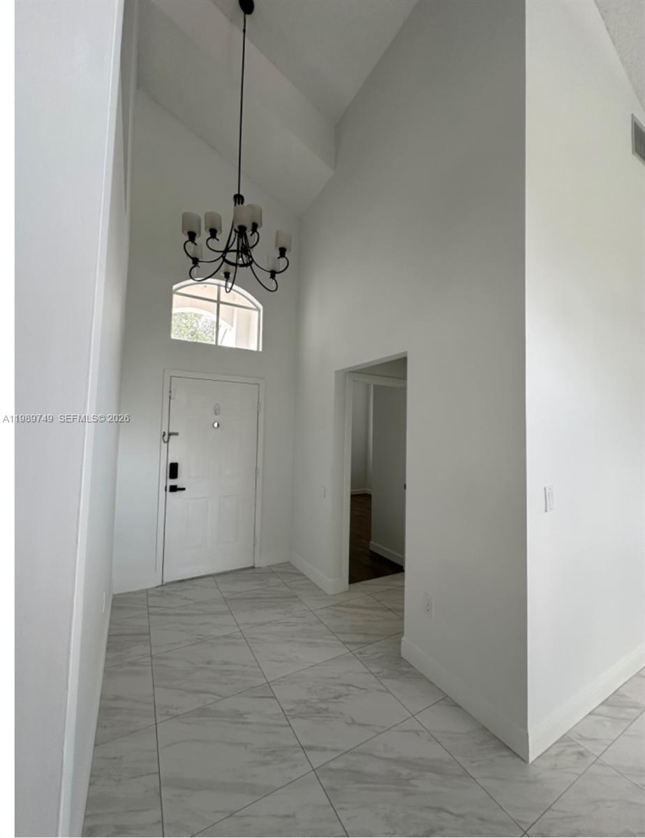 4021 Southwest 153rd Avenue Miramar, FL 33027 - Photo 10 of 42 a view of a hallway with a chandelier