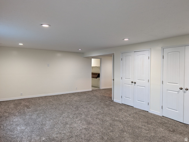 171 South Mustang Road East Grantsville, UT 84029 - Photo 29 of 41 Spacious room featuring neutral paint, recessed lighting, gray carpet flooring, white baseboards, and two sets of double-door closets