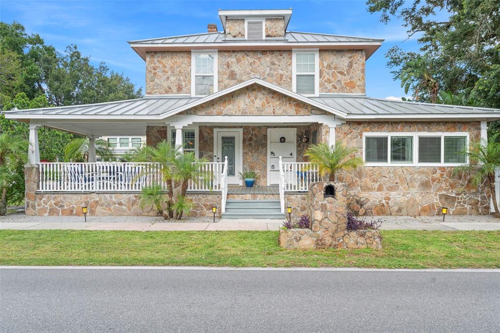 a front view of a house with a yard table and chairs
