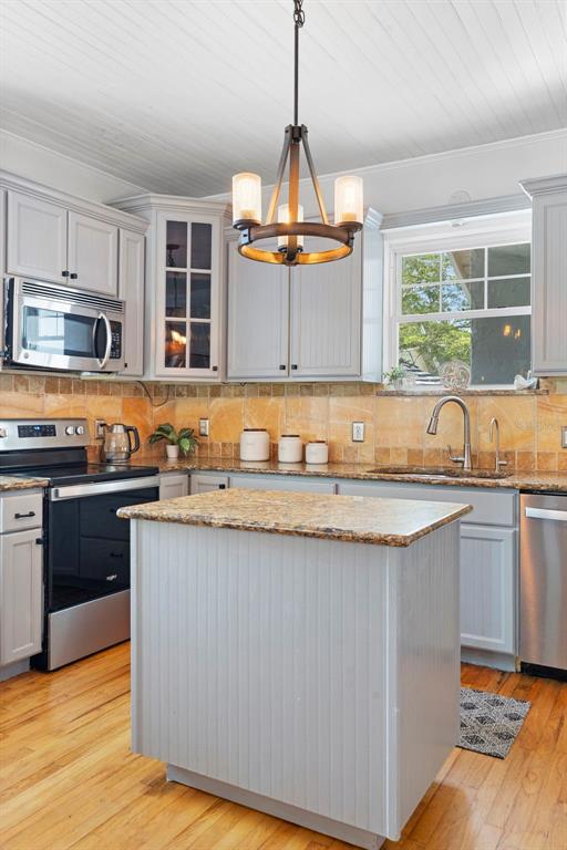 6501 Matchett Road Belle Isle, FL 32809 - Photo 11 of 43 a kitchen with granite countertop a sink and a stove top oven