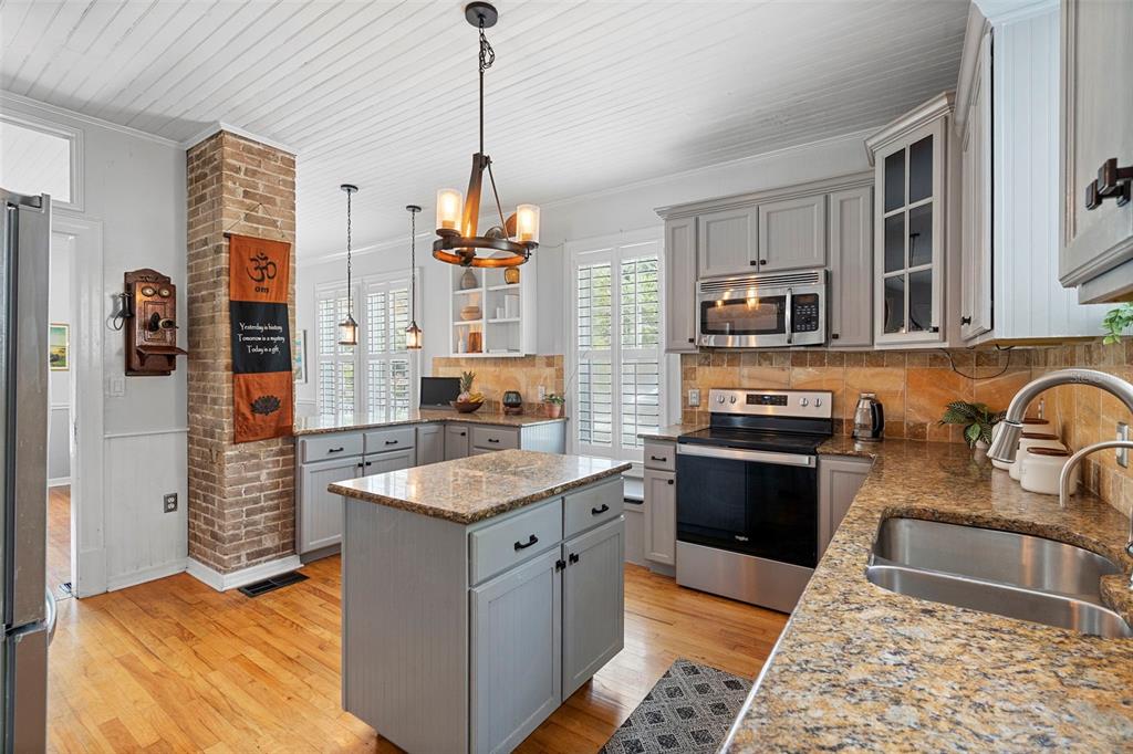 6501 Matchett Road Belle Isle, FL 32809 - Photo 13 of 43 a kitchen with stainless steel appliances granite countertop a sink stove and refrigerator