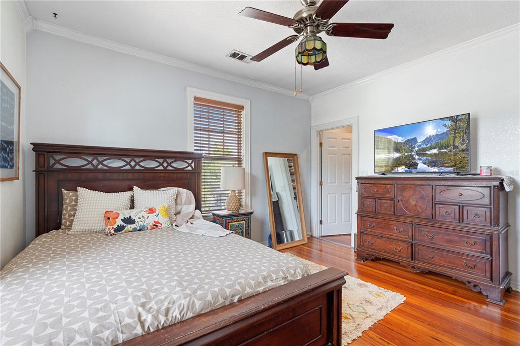 6501 Matchett Road Belle Isle, FL 32809 - Photo 21 of 43 a bedroom with a bed and wooden floor