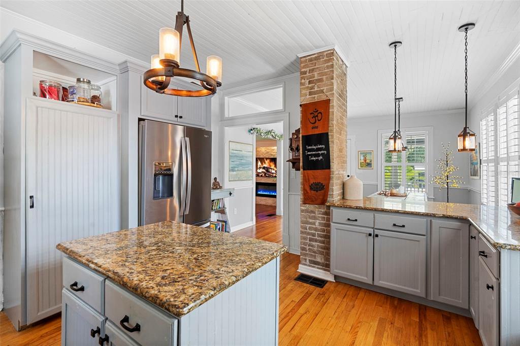 6501 Matchett Road Belle Isle, FL 32809 - Photo 10 of 43 a kitchen with stainless steel appliances granite countertop a sink cabinets and wooden floor