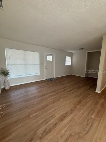 wooden floor in a hall with an empty room