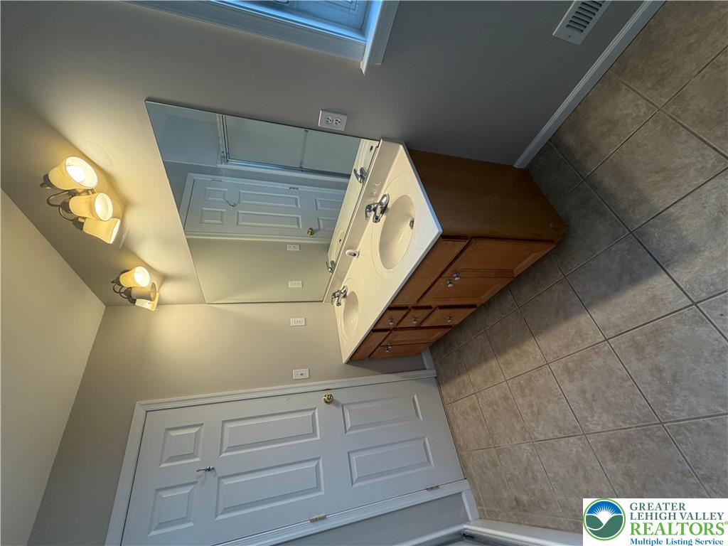 4157 Walter Road Bethlehem, PA 18020 - Photo 17 of 36 A well-lit bathroom with dual sinks provides convenience and style.