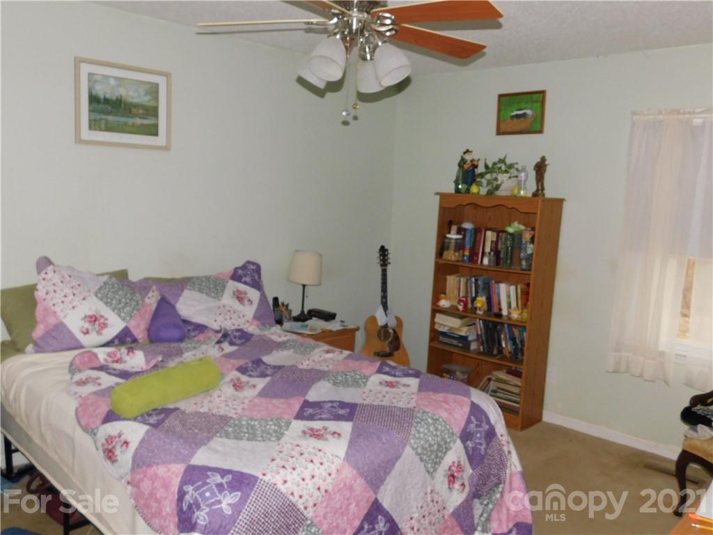 1835 Sharon Road York, SC 29745 - Photo 15 of 21 a bed sitting in a bedroom next to a window with a dresser