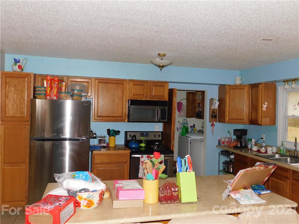 1835 Sharon Road York, SC 29745 - Photo 6 of 21 a kitchen with stainless steel appliances granite countertop a refrigerator and a stove top oven