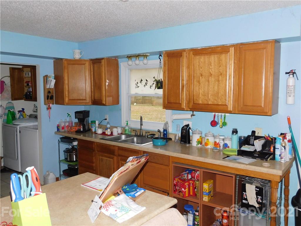 1835 Sharon Road York, SC 29745 - Photo 7 of 21 a kitchen with stainless steel appliances granite countertop a sink dishwasher and cabinets with wooden floor