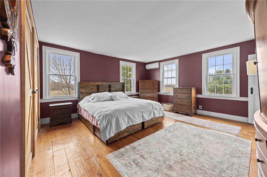 2385 Dow Road York, NY 14533 - Photo 23 of 43 Primary Bedroom with Hardwood Floors, Barn Closet