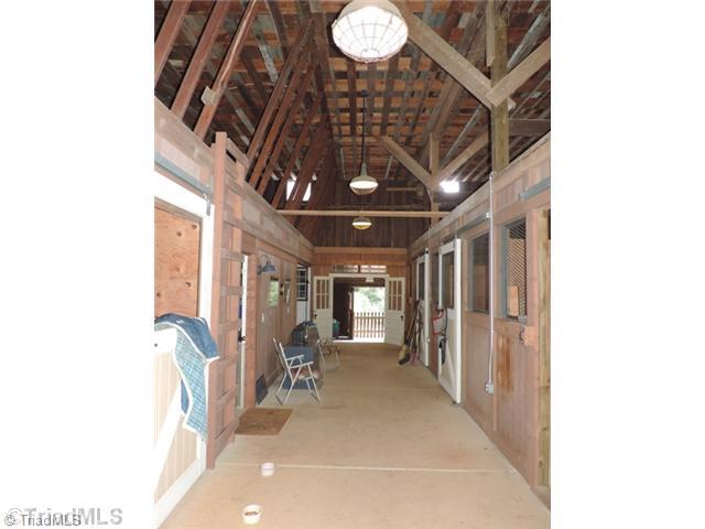 5912 Pepper Road Oak Ridge, NC 27310 - Photo 4 of 15 Stable/Barn. Center aisle is concreted, new light fixtures, new stall doors, new rubber mats.