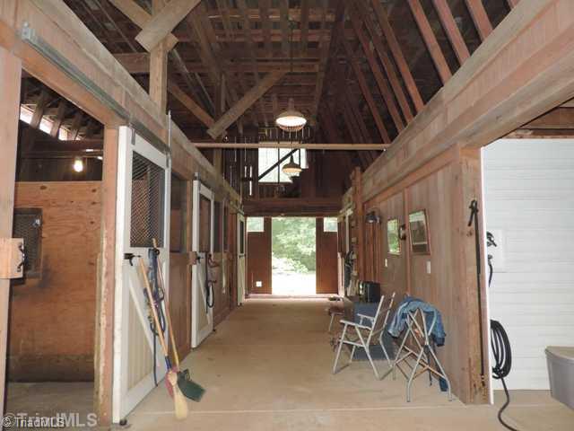 5912 Pepper Road Oak Ridge, NC 27310 - Photo 5 of 15 Stable/Barn. Field run in sheds, enclosed equipment section with concrete floors, stairs to second hay storage and third floor floored open space. One time apartment!