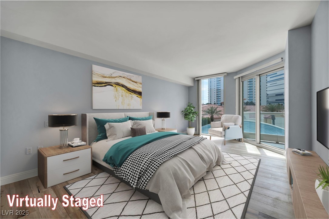2777 Paradise Road, Unit 301 Las Vegas, NV 89109 - Photo 9 of 36 Primary bedroom virtually staged with balcony access